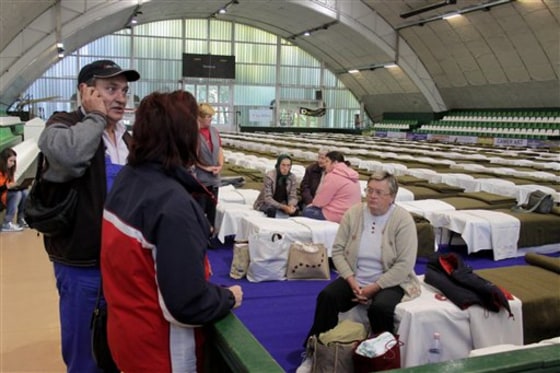 The first residents who were evacuated from toxic red sludge-hit Kolontar village arrive at the temporary shelter set up in the Sports Hall of Ajka, west of Budapest, Hungary, on Saturday.